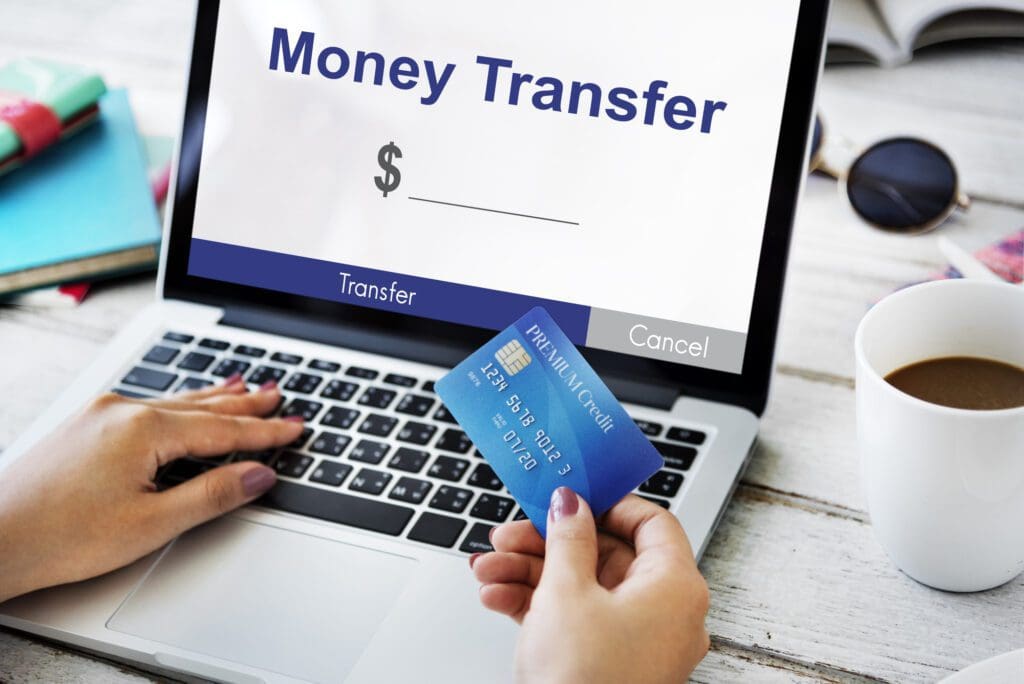 Woman typing on laptop keyboard showing money transfer — Photo