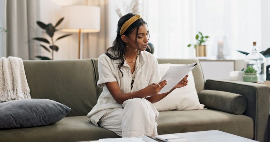 Woman reading documents in home for planning finance