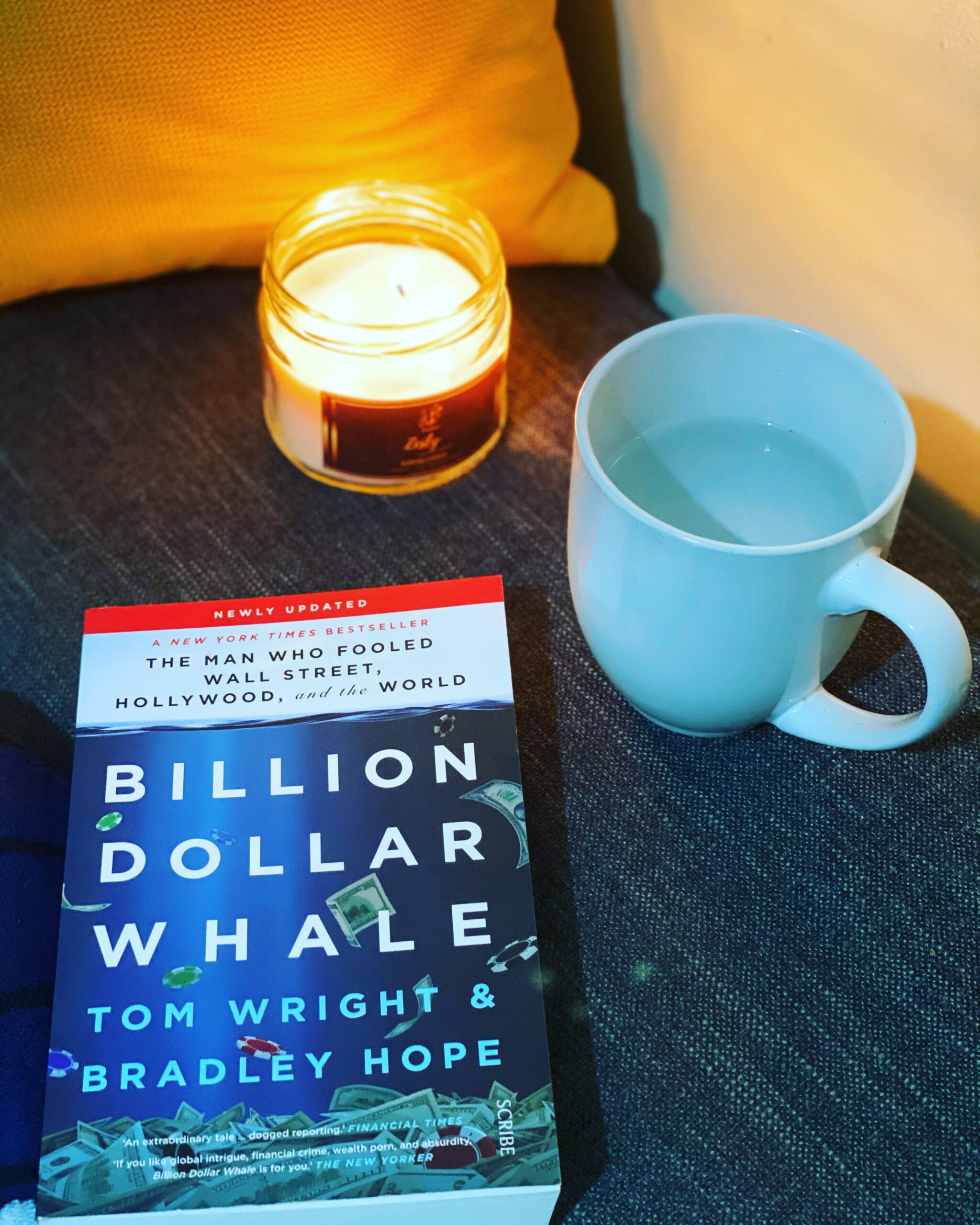Copy of Billion Dollar Whale with a cup of water and a scented candle on the side