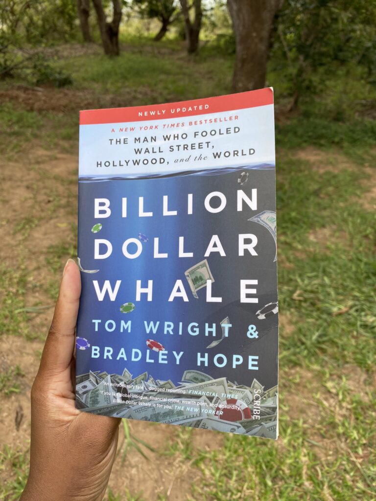 Holding a copy of Billion Dollar Whale