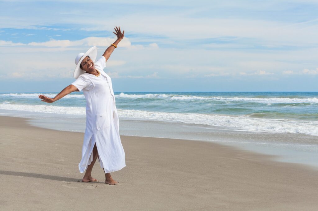 Elderly lady enjoying on the beach: 5 Money Lessons I Learned in My 20's 2