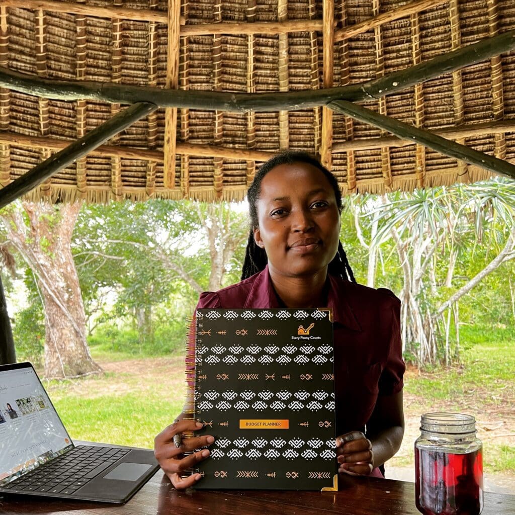 A lady holding a budget planner book for financial planning