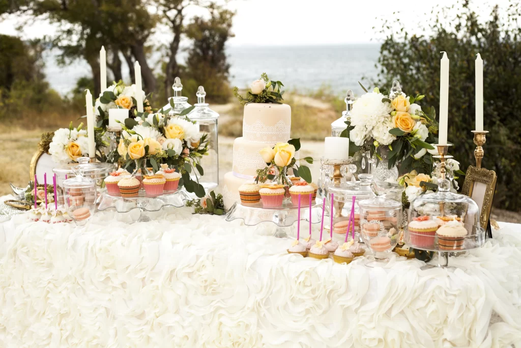 A wedding cake and cupcakes banquet 