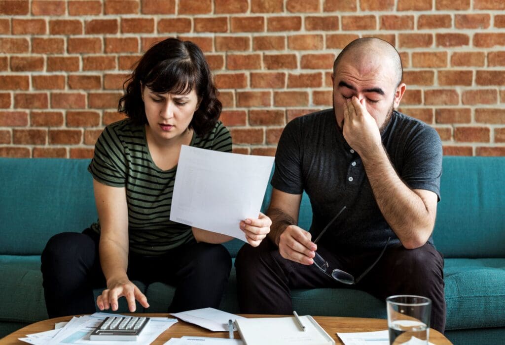 Young couple going over finances looking stressed
