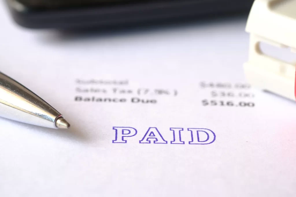 paid-invoice-and-rubber-stamp-on-paper-