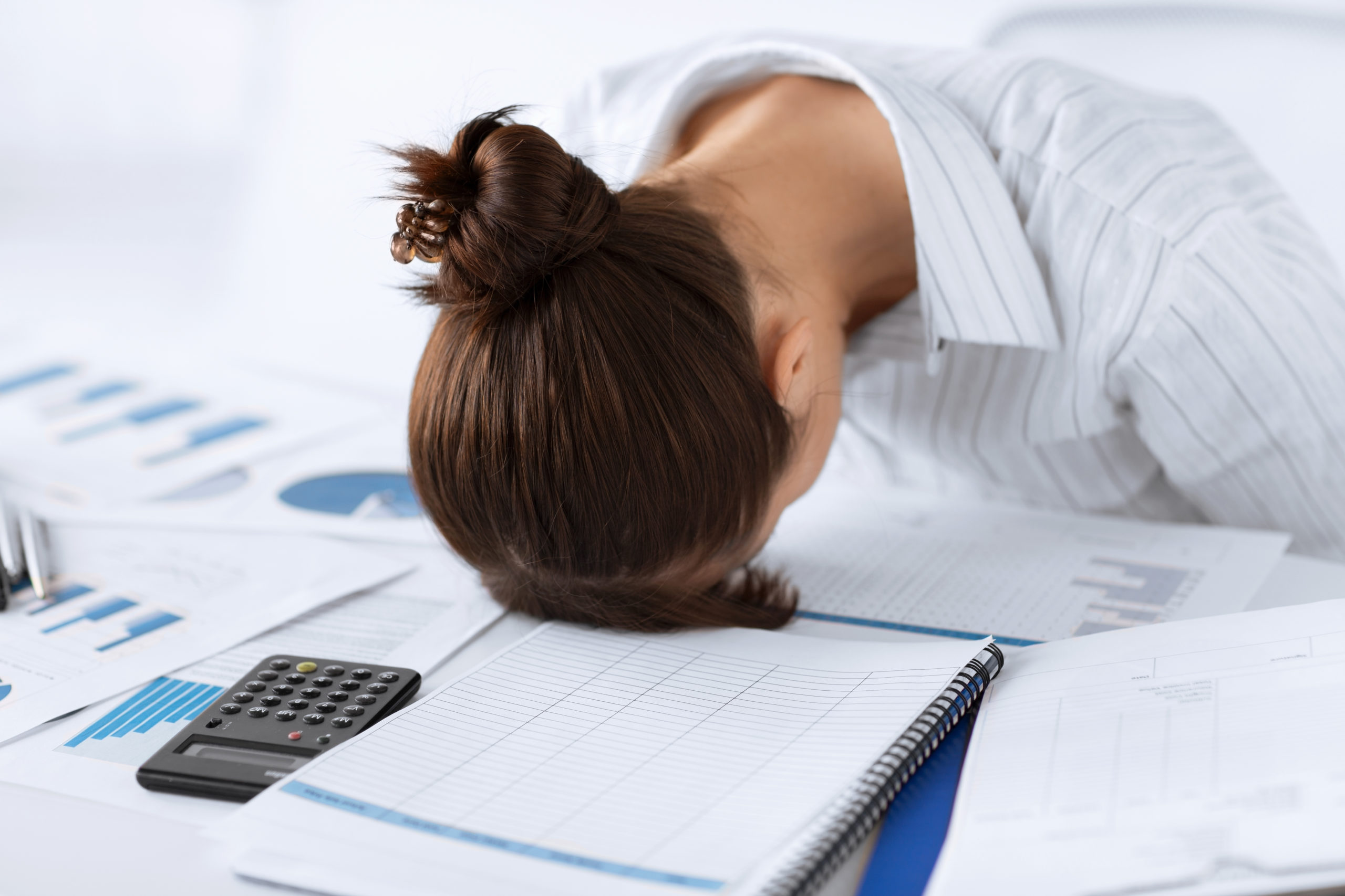 picture of woman sleeping at work in funny pose on a pile of paperwork for lack of online accounting software