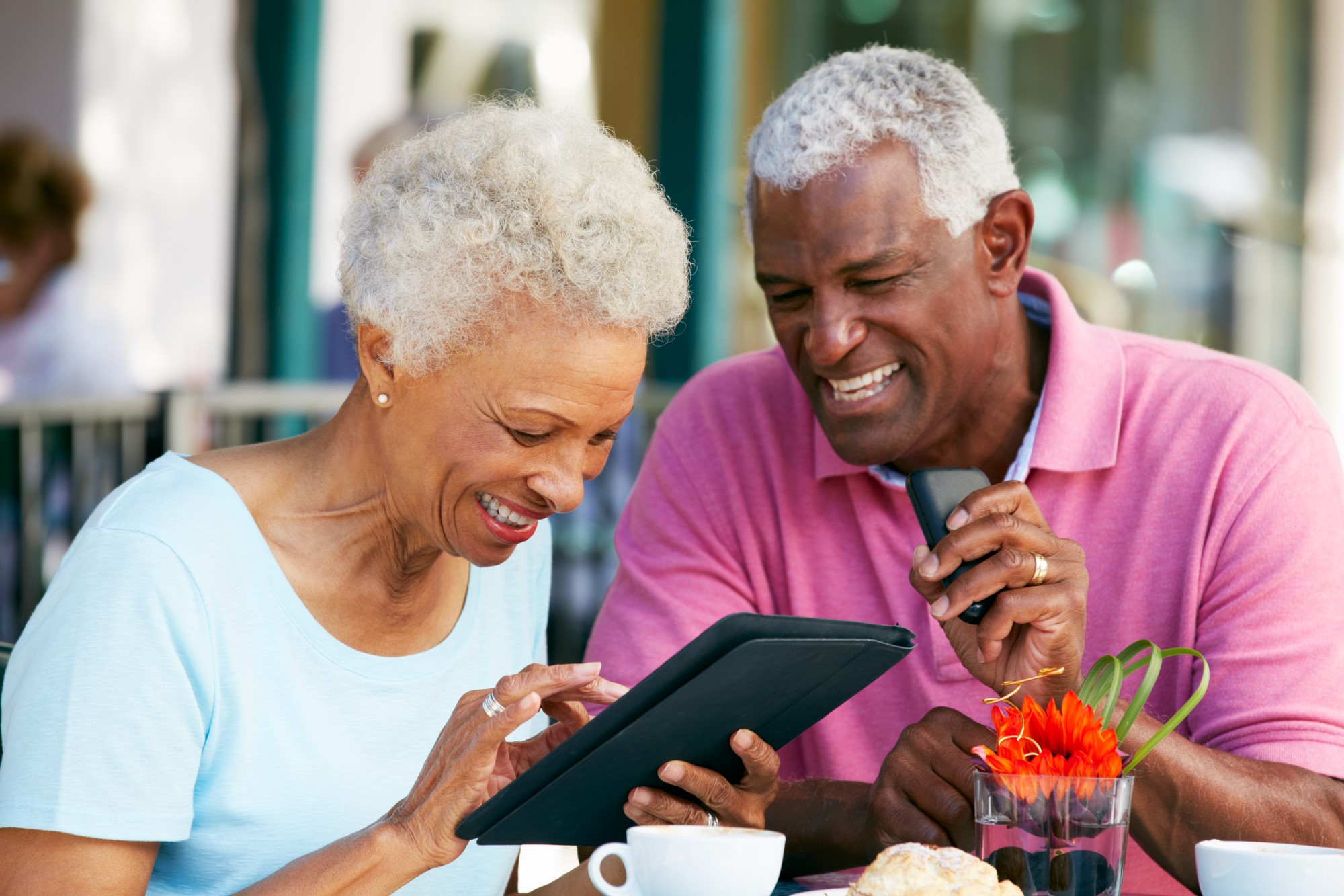 Old couple looking at their tablet