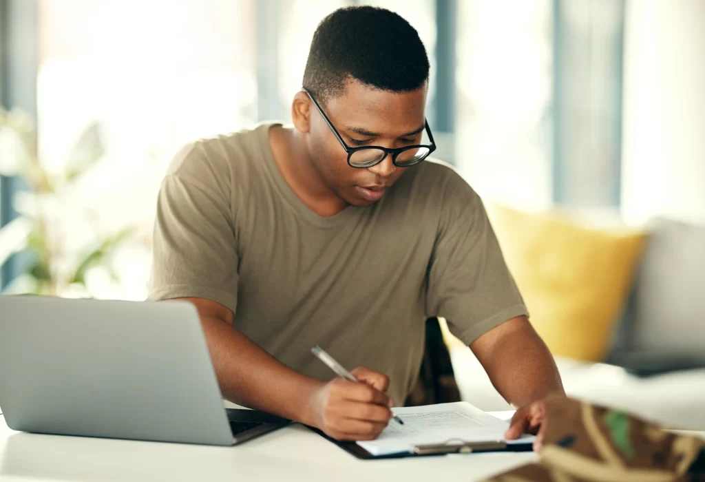 Startup budget-planning-and-black-man-with-remote-work-setup