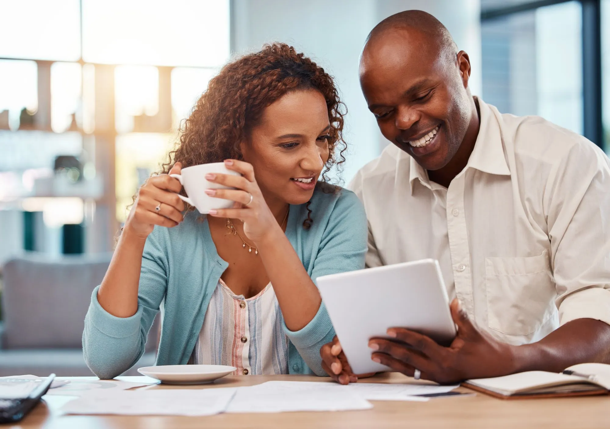 happy-couple-tablet-and-planning-for-finance-How to Build Wealth in Kenya