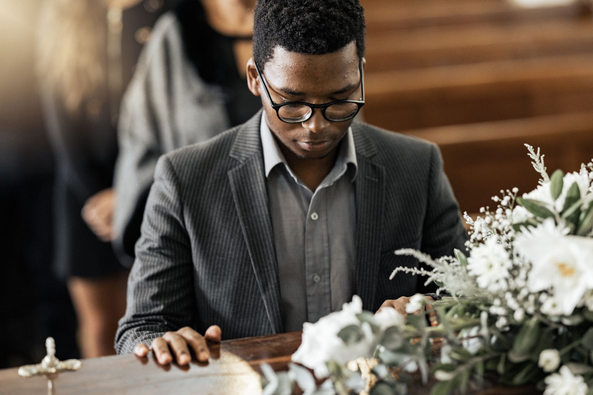 Funeral coffin, death and black man sad, grieving and mourning loss of a loved one-Benevolent Fund