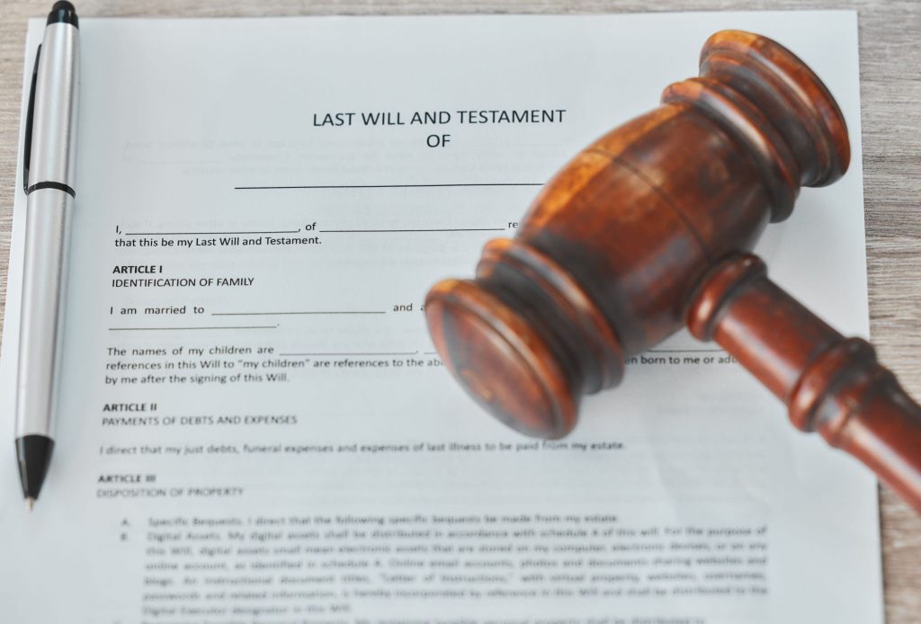 Pen, last will and testament with contract, gavel and legal aid with law and document on a desk- how to write a will